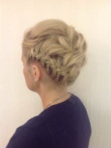 A braided updo hairstyle featuring multiple braids and a bun at the back of the head.