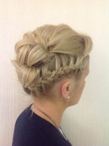 Elegant braided updo hairstyle showcasing intricate braiding techniques on blonde hair.
